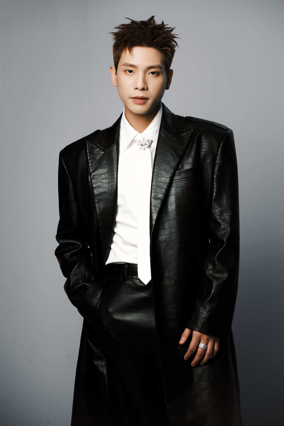 Quân A.P official artist portrait in black suit