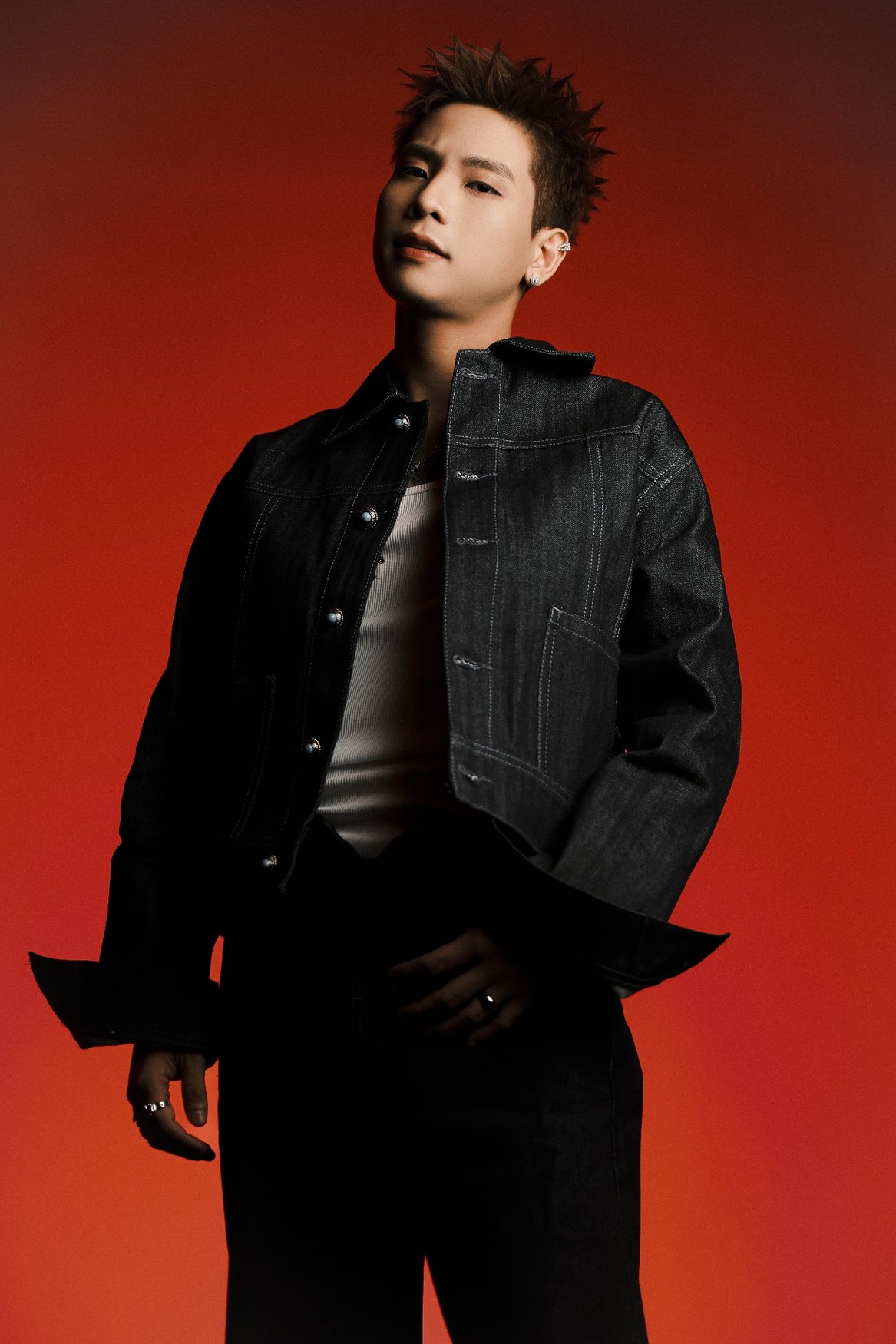 Quân A.P performance-style editorial photo on red background